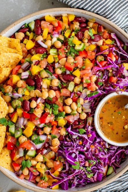 Colorful Southwest bean salad with chickpeas, kidney beans, bell peppers, cabbage, and zesty dressing