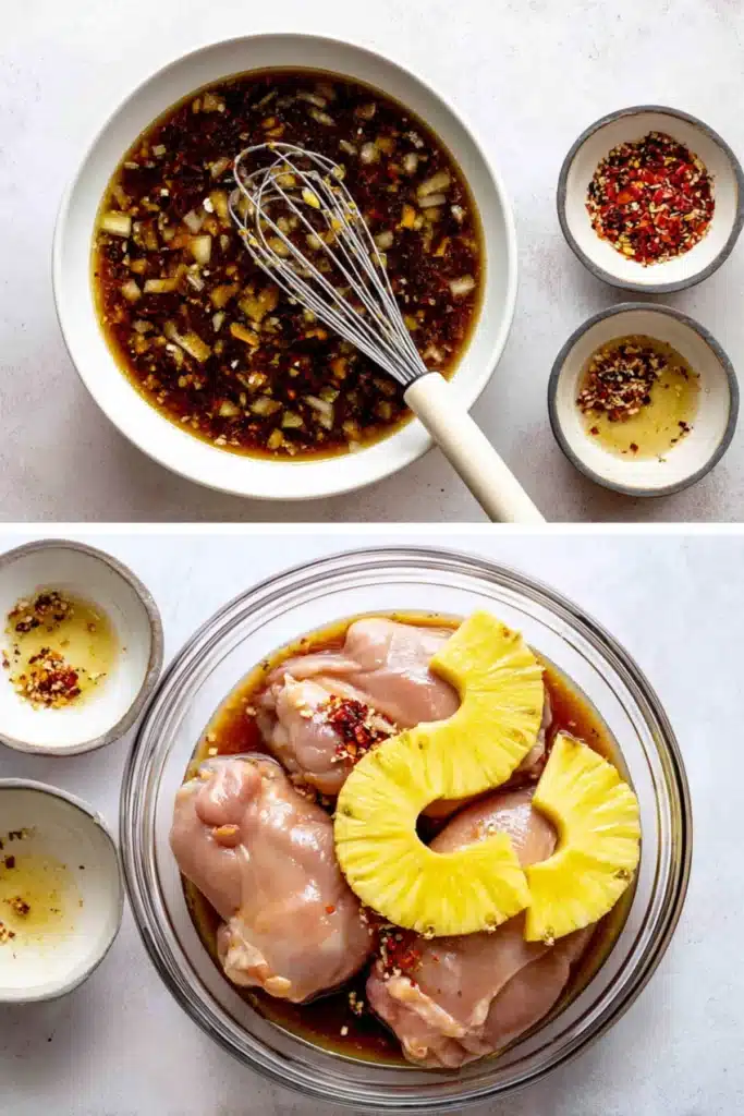 Chicken thighs marinating in sweet Hawaiian BBQ sauce with pineapple rings and chili flakes in a glass bowl