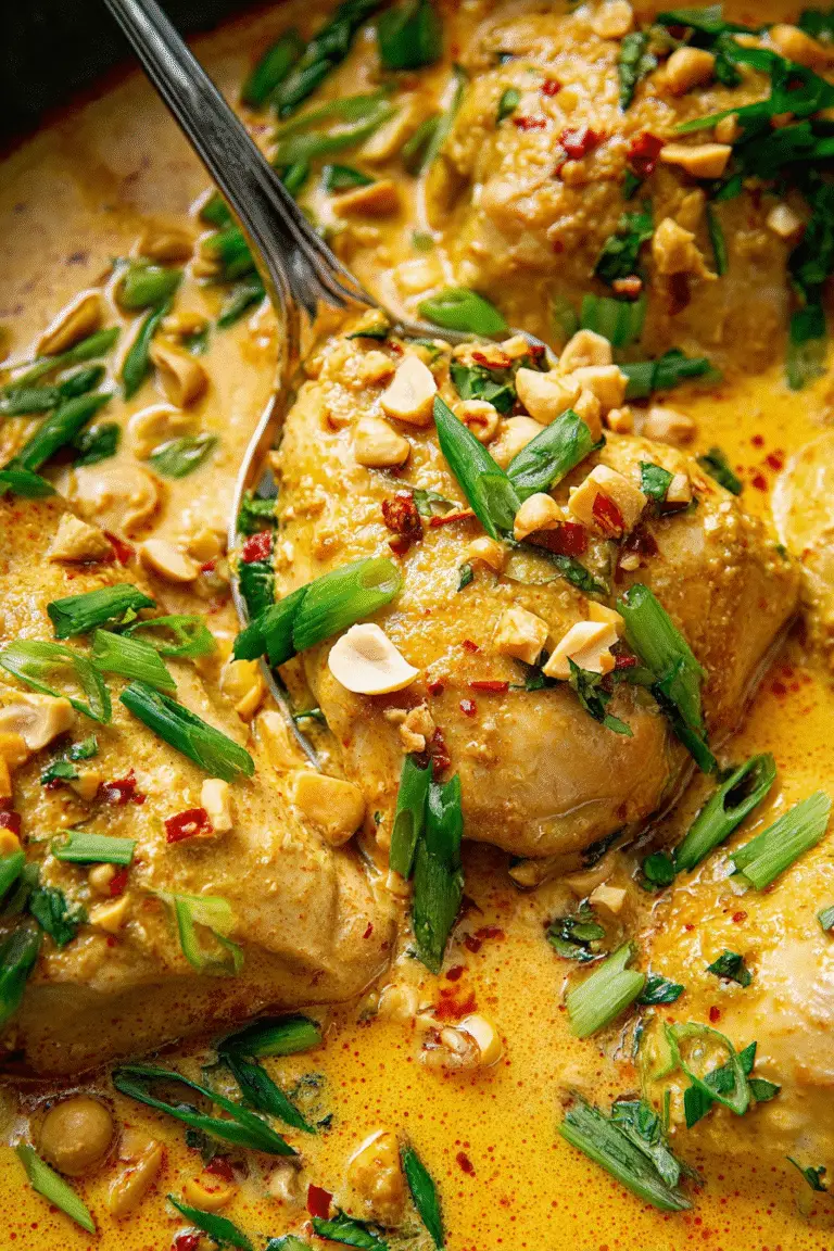 Juicy chicken simmered in creamy coconut lime sauce, topped with scallions, chili flakes, and crushed peanuts.