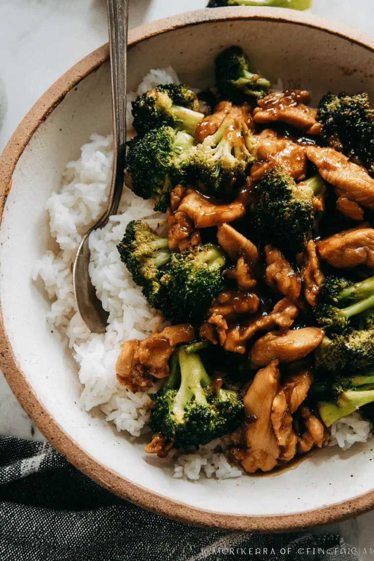 Chicken and Broccoli with Rice, top-down view, tender chicken pieces and vibrant broccoli florets coated in glossy brown stir-fry sauce,