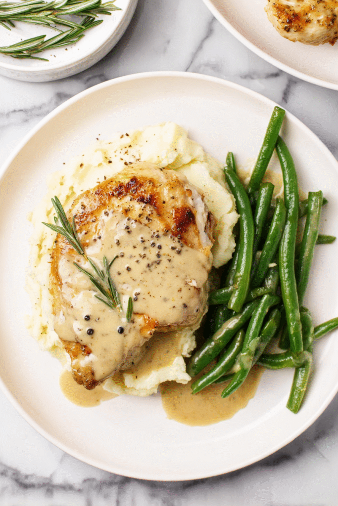 Creamy Dijon Rosemary Chicken, top-down view, golden seared chicken breast drizzled with creamy Dijon rosemary sauce,