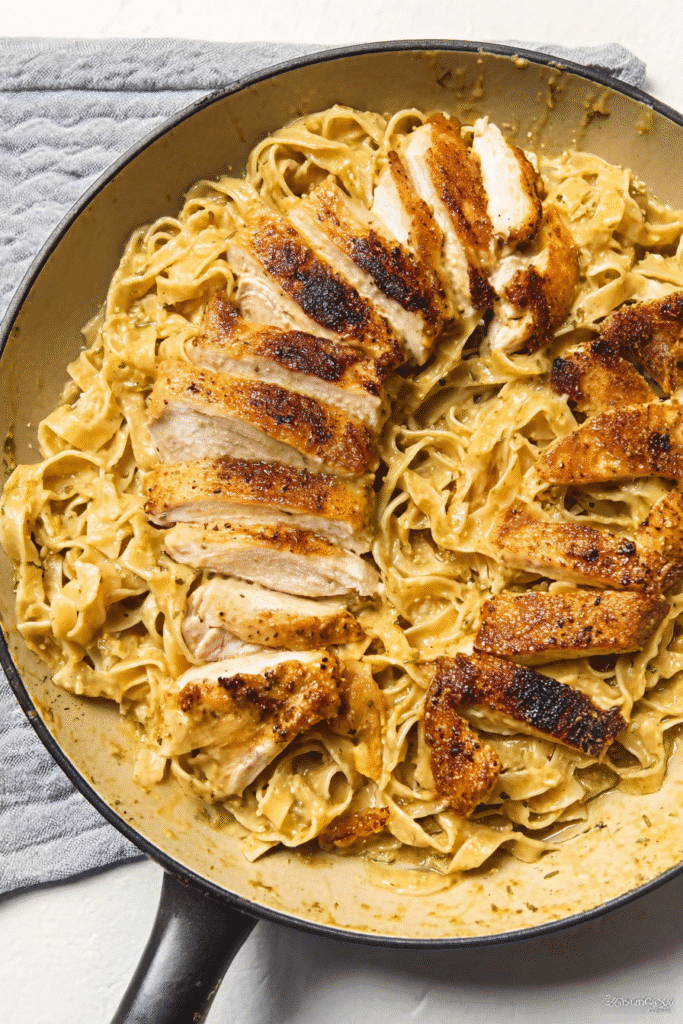 MidJourney prompt based on your image and recipe style Prompt One-Pan Chicken with Buttered Noodles, top-down view, homemade cozy dinner style,