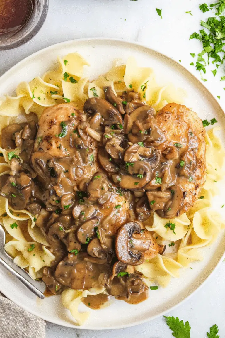 One-Pan Chicken Marsala, top-down view, golden chicken breasts in creamy Marsala mushroom sauce