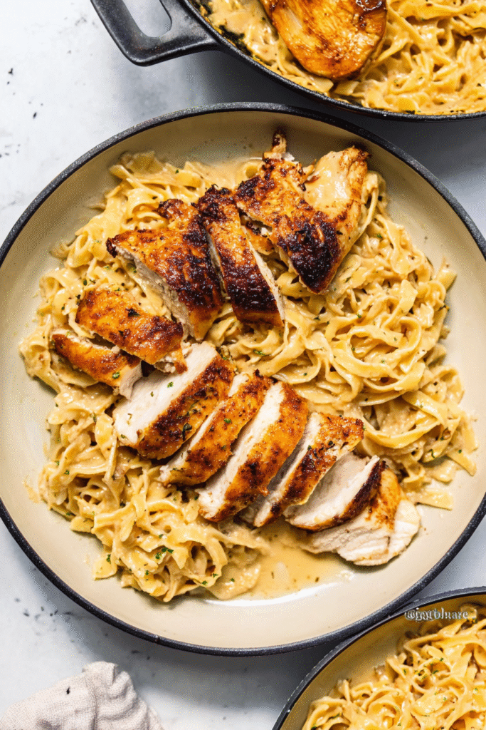 One-Pan Chicken with Buttered Noodles, top-down view, homemade cozy dinner style, juicy golden-brown seared